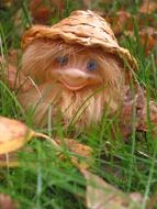 funny gnome in a hat with a beard in the garden