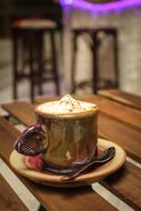 creamy drink in a golden mug