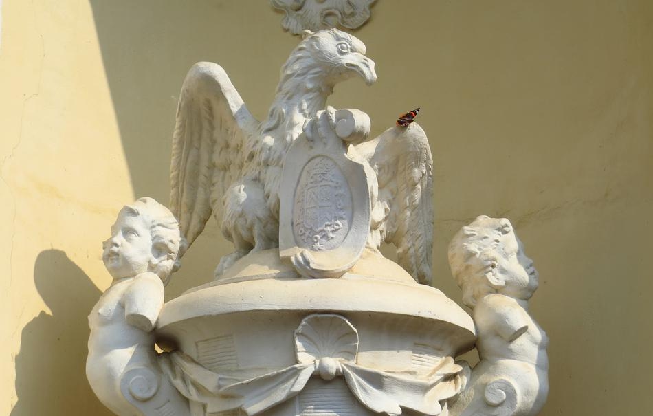 stone statues of eagles in front of the building