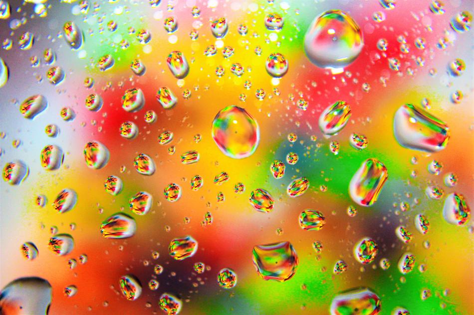 raindrops on the glass of the colored background