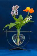 flowers in a vase in the form of a heart
