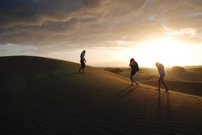 people walking in the sun in the desert