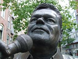 André Hazes with microphone, sculpture of Singer in city, netherlands, amsterdam