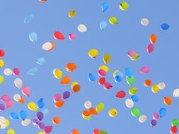 colored balloons in the blue sky in the sunlight