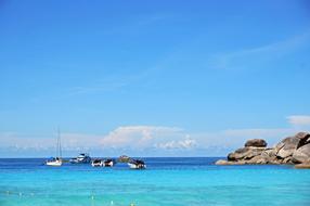 boats floating in the blue ocean