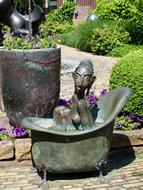 sculpture of a girl in a bathtub