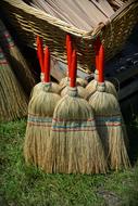 large brooms by the house