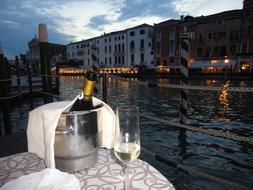 bottle of champagne in a bucket with glasses on the table