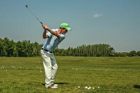 man plays golf