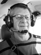 old man piloting an airplane