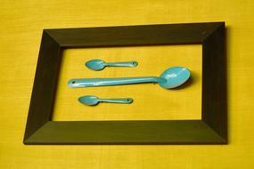 iron spoons on a yellow background