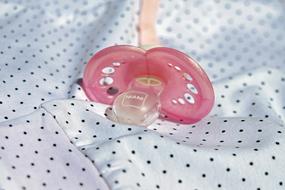 baby pink pacifier on the table