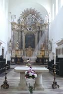 an altar in a church decorated with flowers