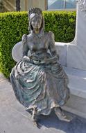 Old Bronze Statue of Empress Sisi Sitting on a Bench