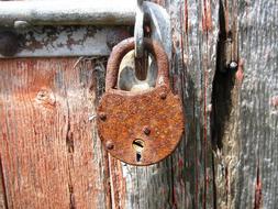 Rusty lock on a wooden door