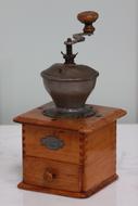 old coffee grinder against the wall