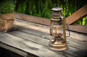 Old Kerosene Lamp Shining on a Wooden Table