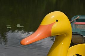 a boat in the form of a duck in a lake