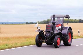 tractor passing on the road in the village