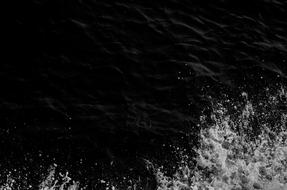 splashing water in a black lake