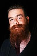bearded man on black background