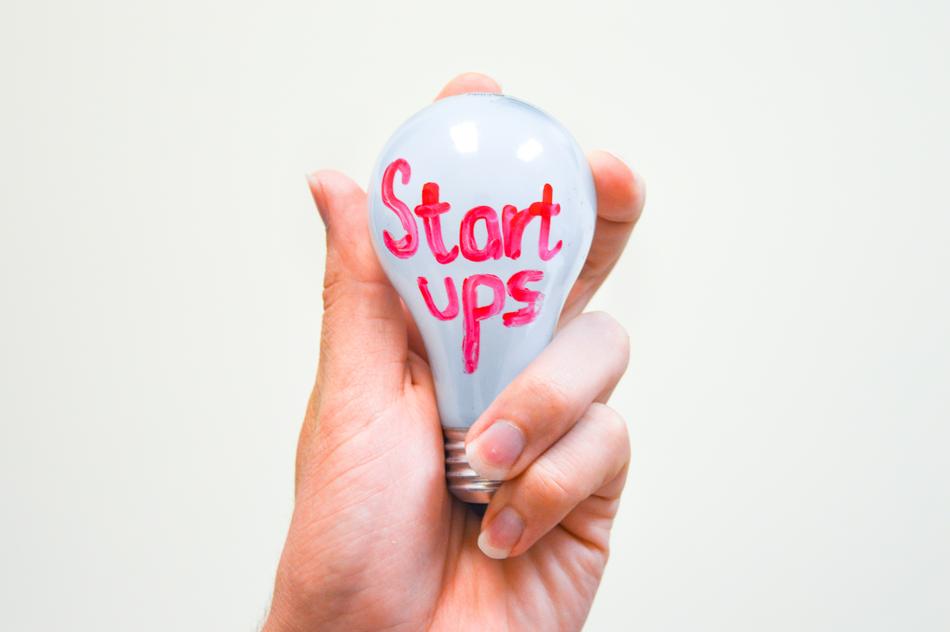 light bulb in hand with signature