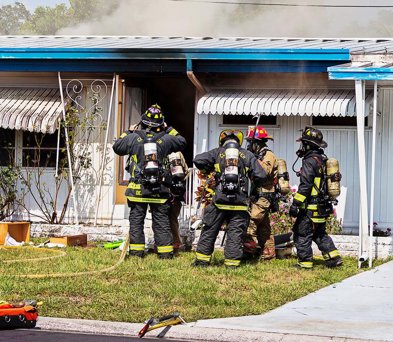 a company of firemen in front of the building