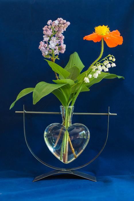 flowers in a vase in the form of a heart
