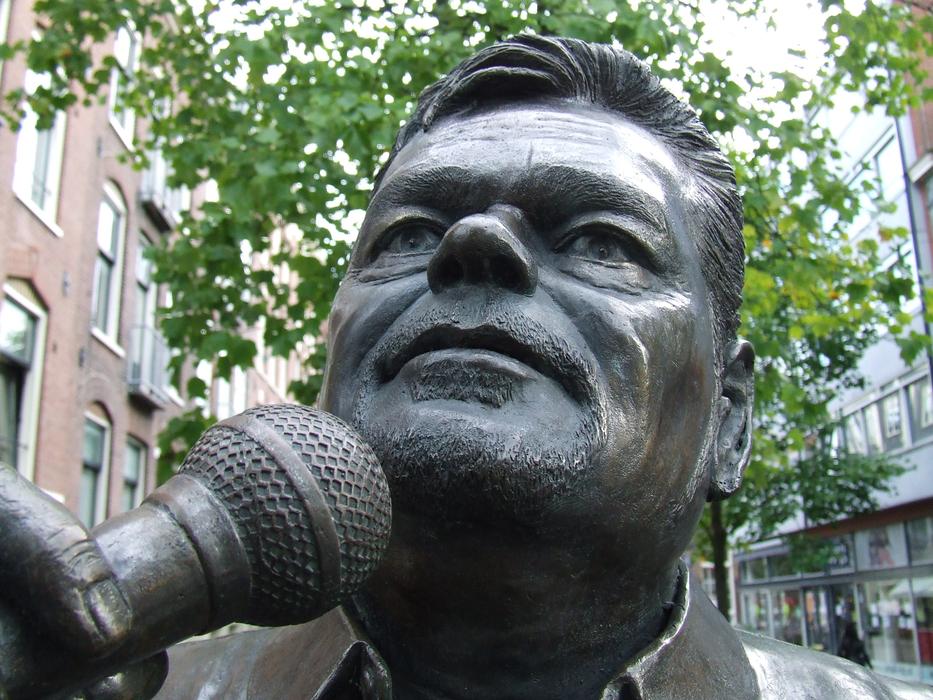André Hazes with microphone, sculpture of Singer in city, netherlands, amsterdam