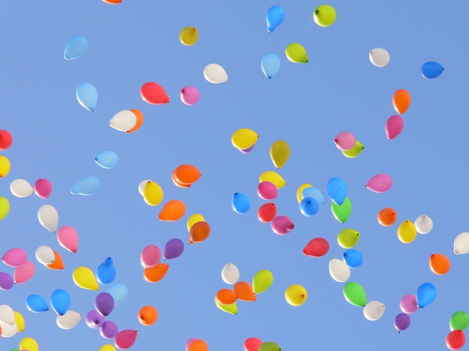 colored balloons in the blue sky in the sunlight
