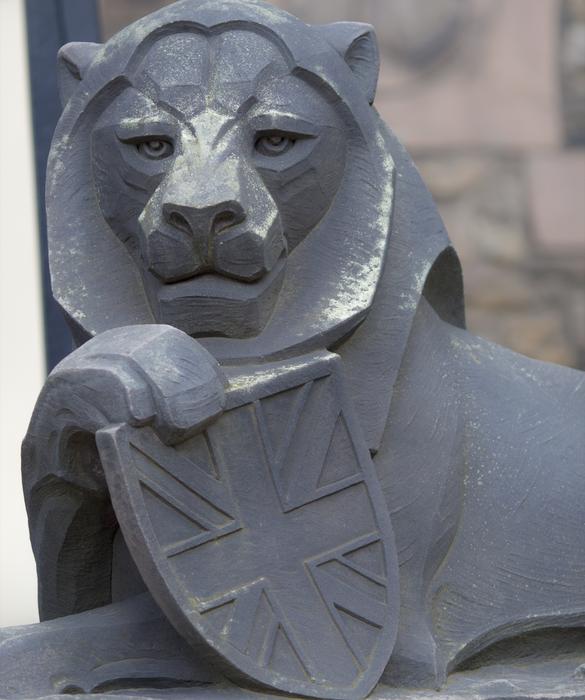 Stone sculpture of a lion with a shield