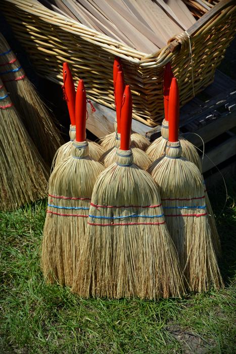 large brooms by the house
