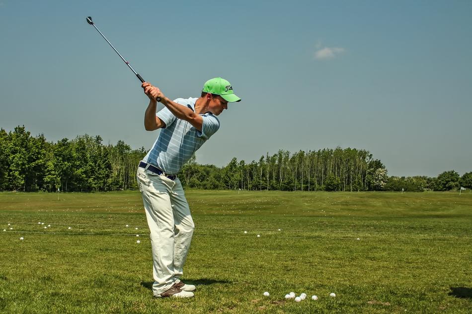 man plays golf