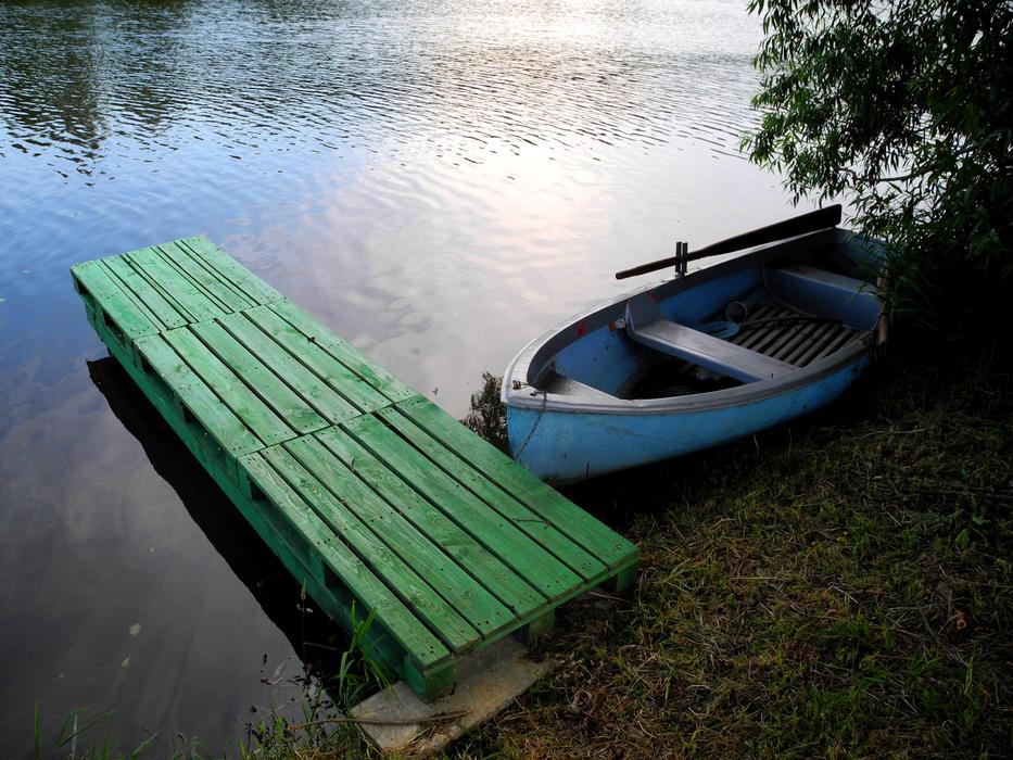 old wooden boat by the bridge