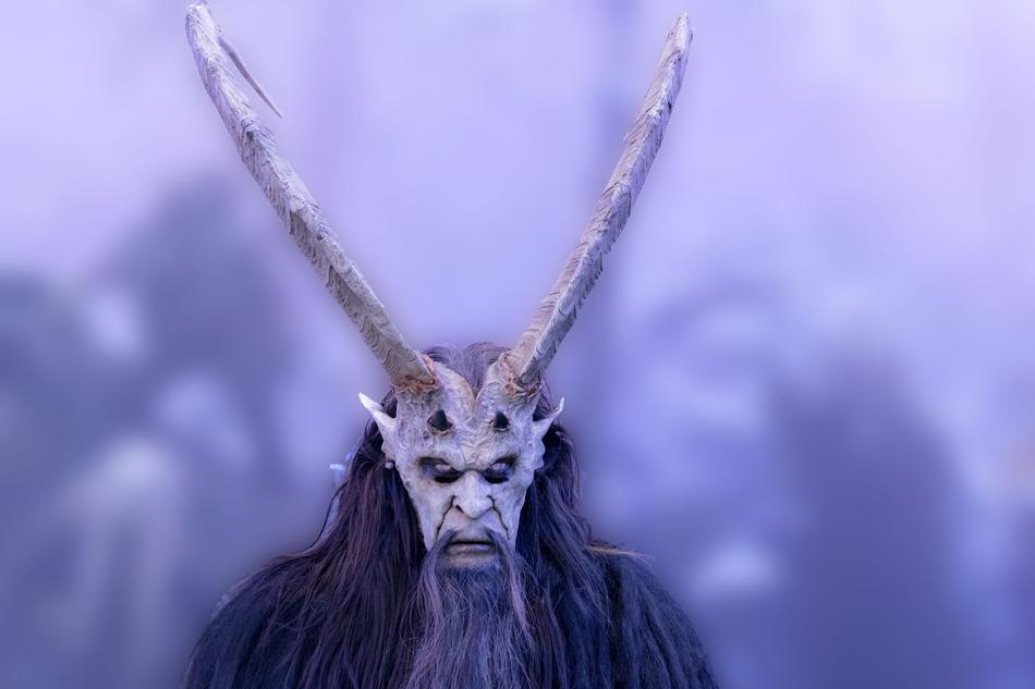 man in a mask with long horns