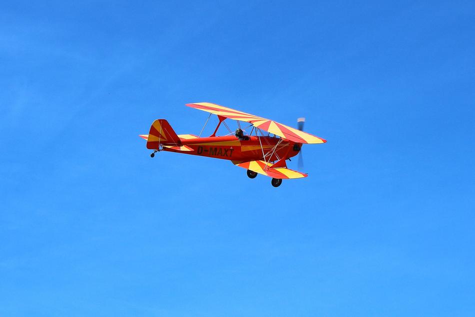 Small Red Airplane in the Blue Sky