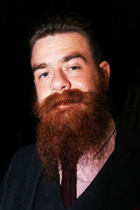 bearded man on black background