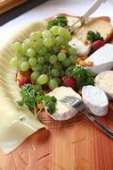 grapes and cheese in a plate