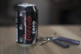 a black Coke can on the table