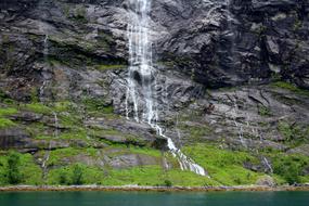 high rock with a waterfall