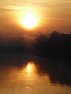 the sun illuminating the river
