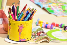 colored pencils in a pretty glass on the table