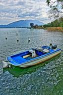 boat with a motor on the beach by the river