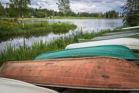old boats by the river in the grass