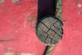 wooden stake in the red wall
