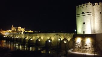 Bridge illuminated by lanterns