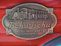 iron sign with a train on a wooden wall
