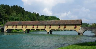 wooden bridge over the river with a roof