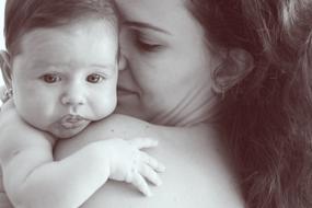mother with her baby on her shoulder