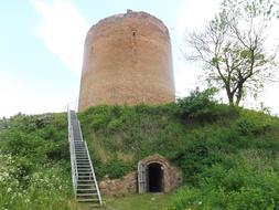 stone old tower overgrown with grass